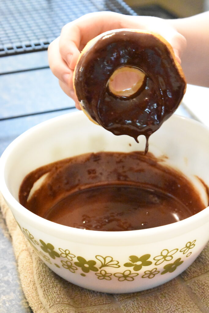 dipping donuts in chocolate glaze 