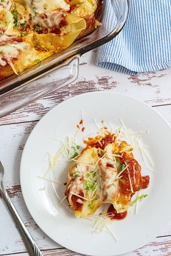A white plate with stuffed shells 