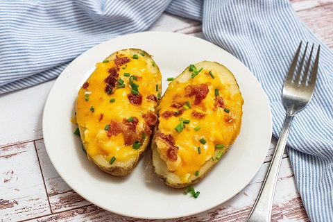 twice baked potatoes on a white plate 