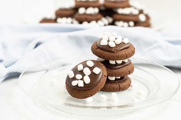 A clear glass plate with a stack of hot choclate cookies