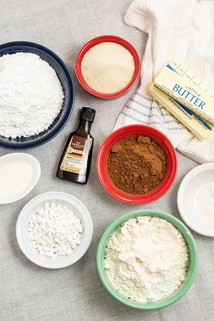Ingredients for hot chocolate cookies, hot cocoa, flour, sugar, butter, baking soda, baking powder, salt vanilla and powdered sugar