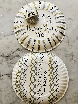 Two paper plates with the back side decorated 