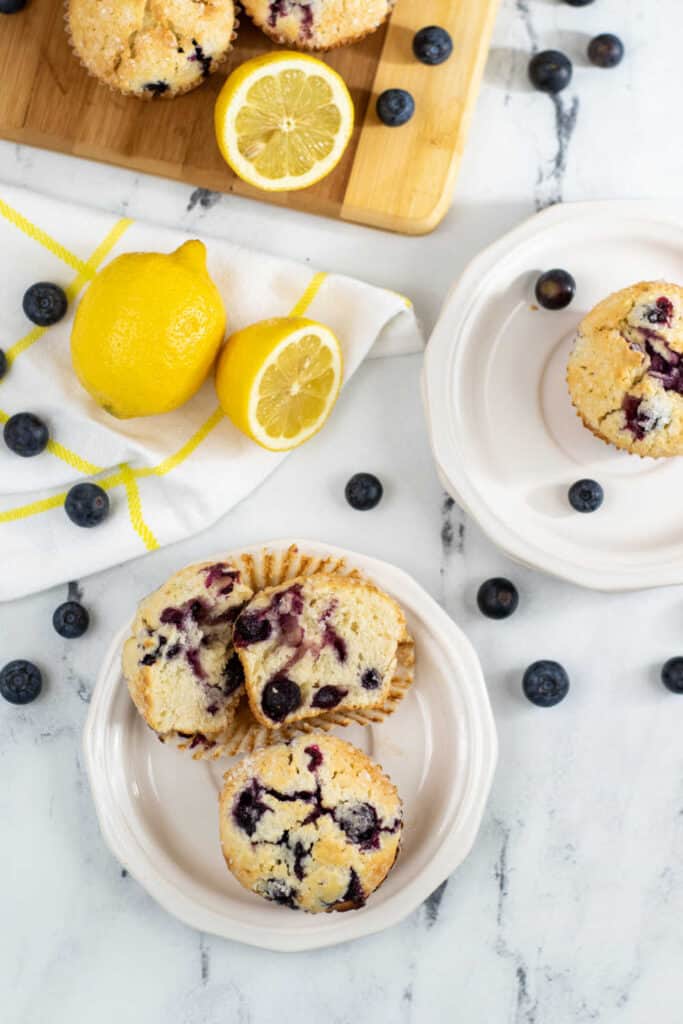 Muffins, blueberries and lemons on a marble countertop 