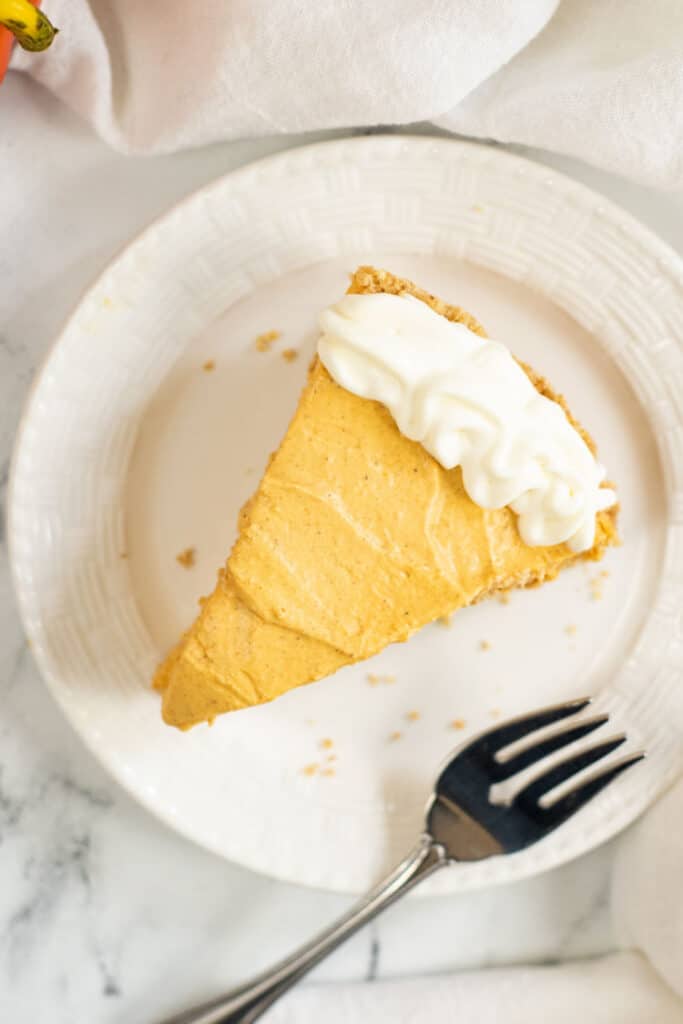 a piece of no bake pumpkin cheesecake on a white plate 