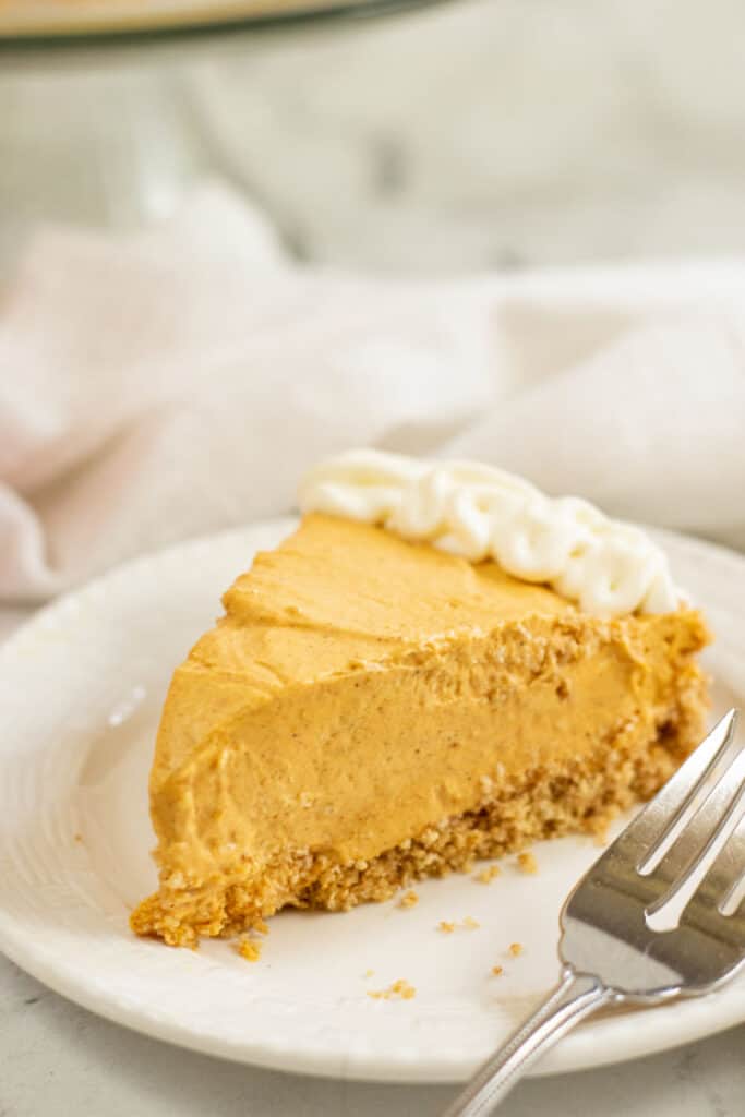 a piece of no bake pumpkin cheesecake  on a white plate 