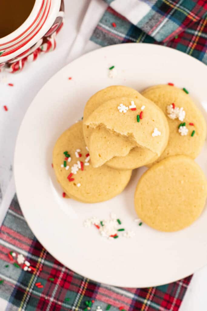 A pile of sugar cookies on white plate