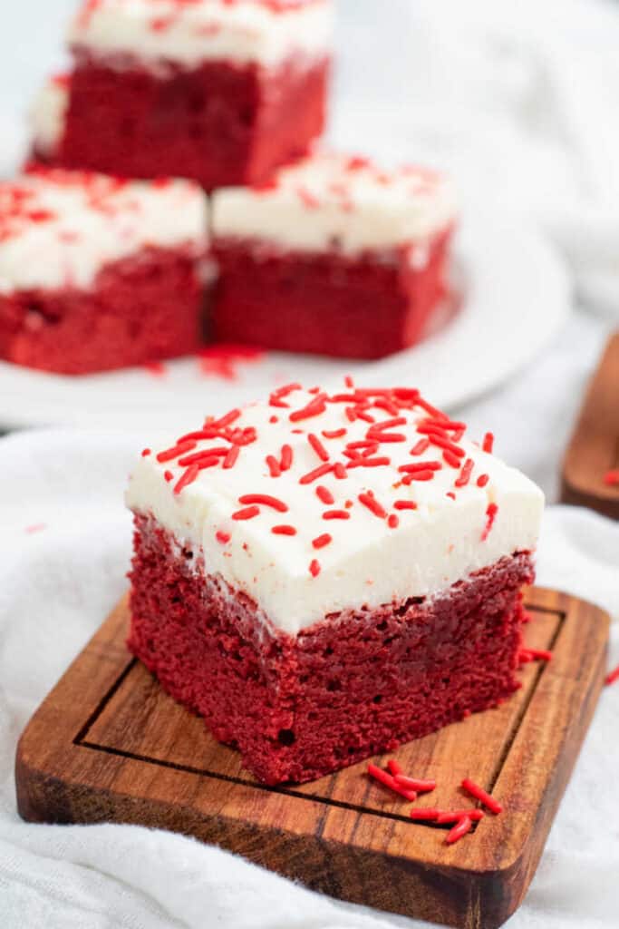 A red velvet brownie on a small wooden chopping block 