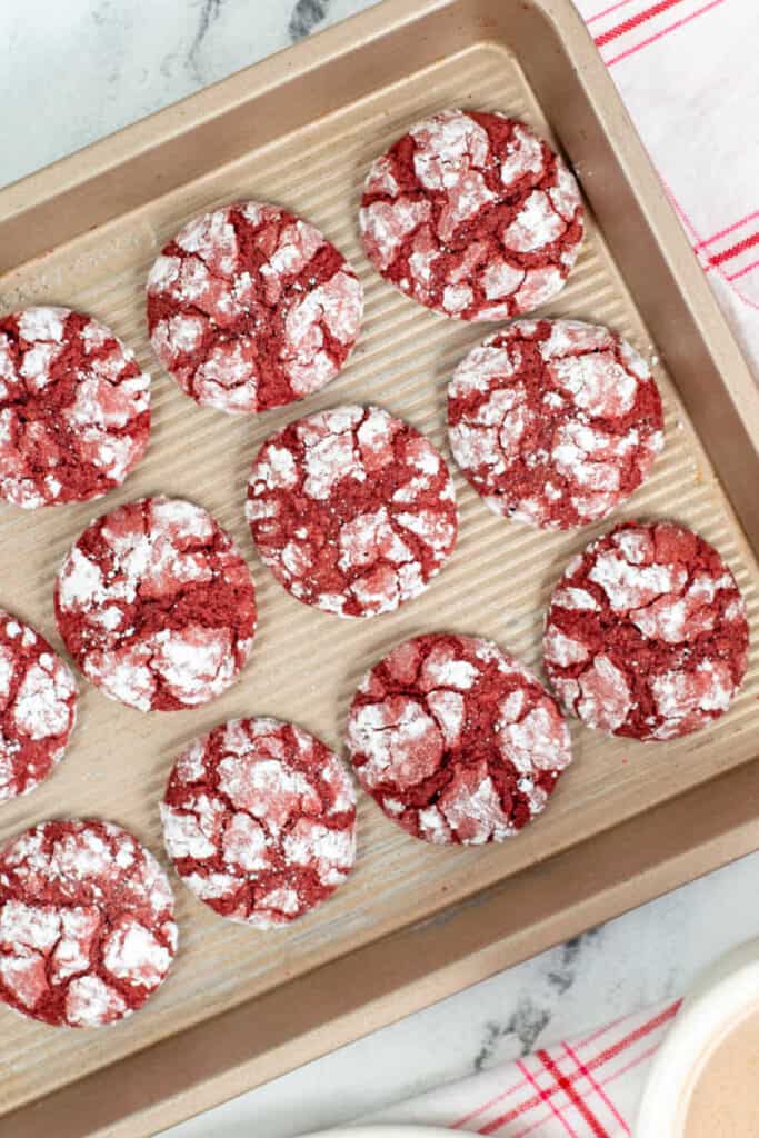 A baking sheet lined with red velvet crinkle cookies 