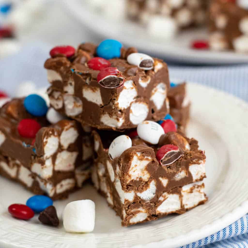A pile of marshmallow chocolate bars on a white plate 