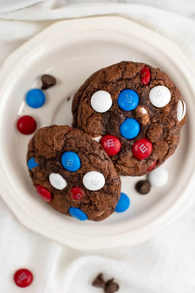 A stack of chocolate cookies on a white plate