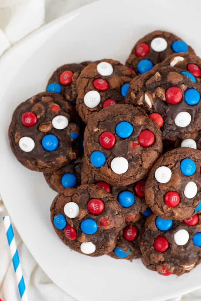 A stack of brownie cookies decorated with red white and blue M&M's
