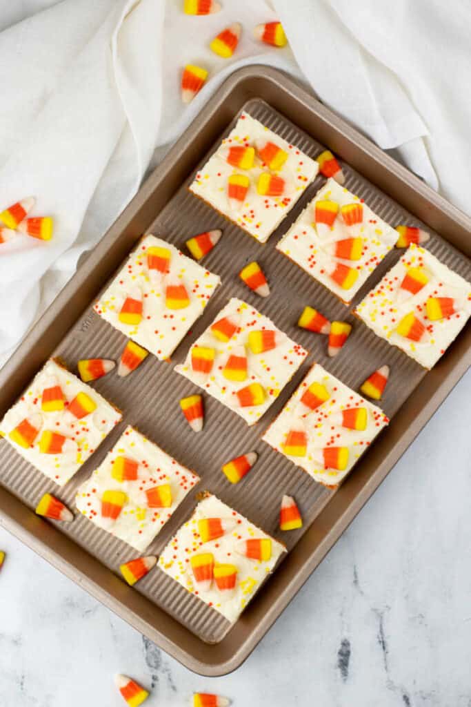 A baking sheet with candy corn cookie bars on it. 