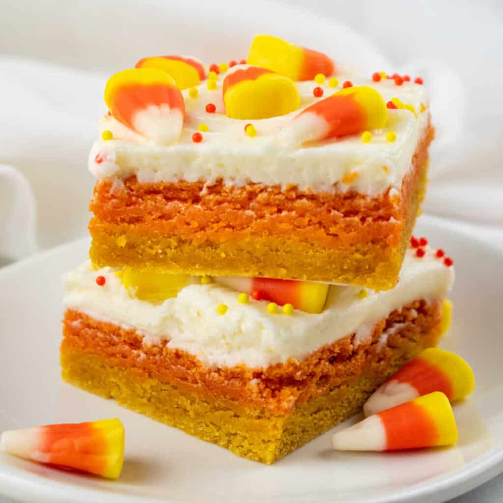 Two candy corn cookie bars stacked on top of each other. 