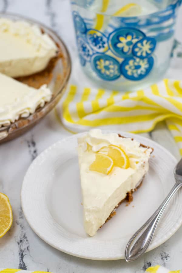 a piece of lemon pie on a white plate. 