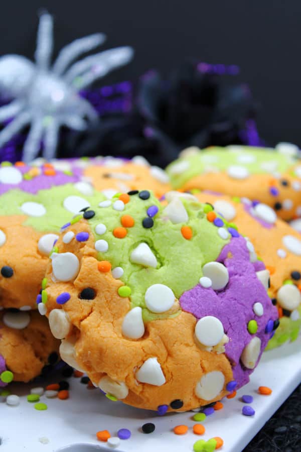 A close up of a green orange and purple Hocus Pocus cookie 