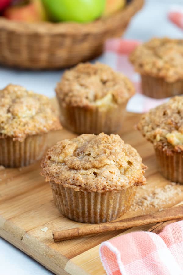 Apple cinnamon muffins on a wooden chopping block 