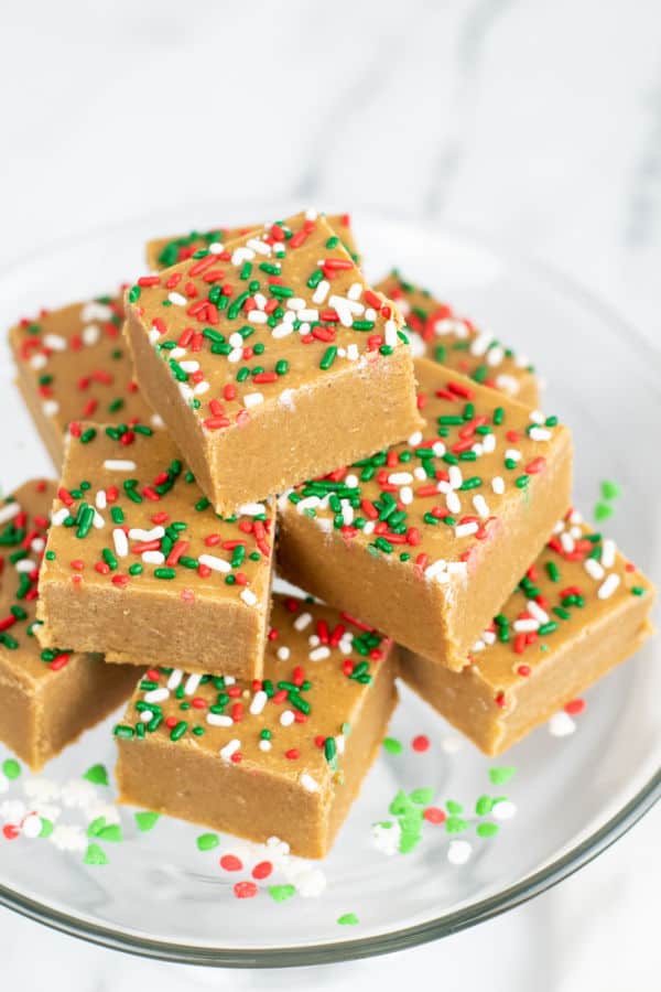 A pile of gingerbread fudge on a clear plate. 