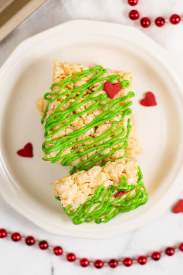 A stack of Grinch rice krispie treats on a small white plate. 