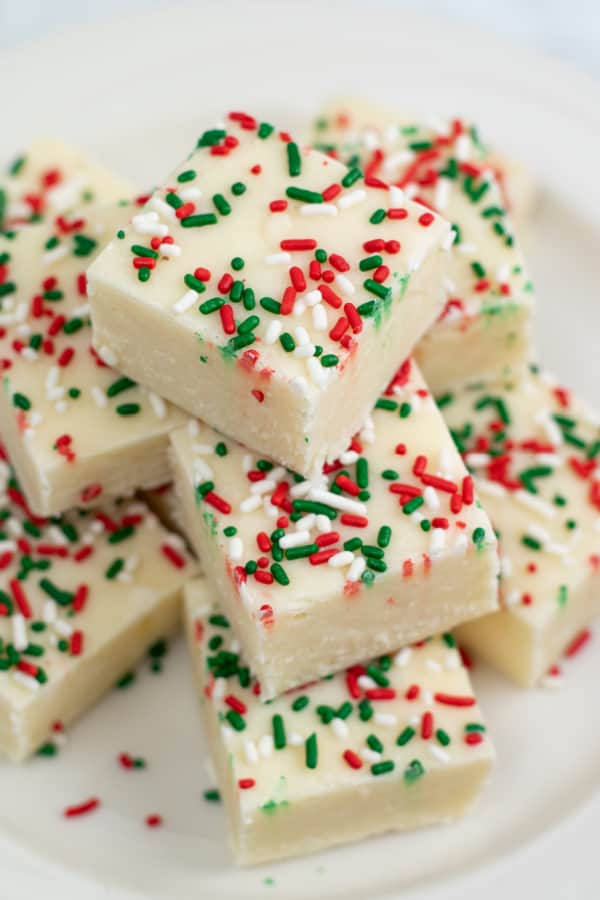 A pile of sugar cookie fudge with Christmas sprinkles. 