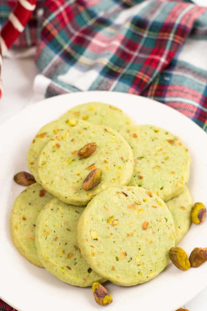 A plate full of pistachio icebox cookies. 