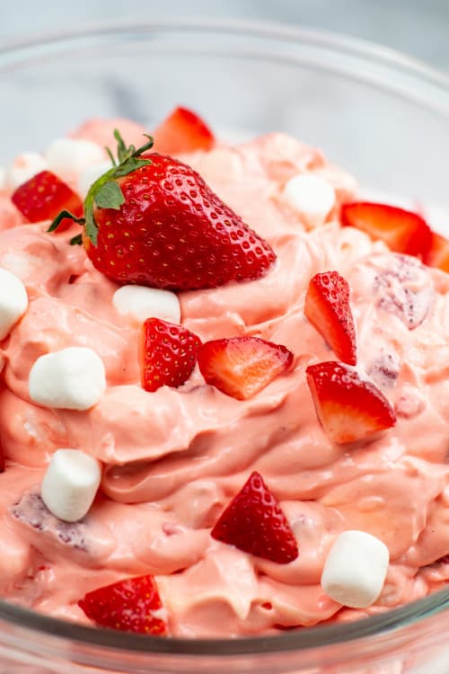 A close-up of a glass bowl of strawberry fluff.