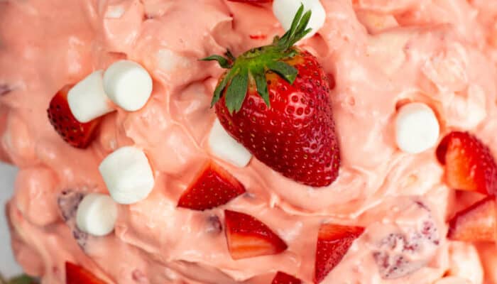 An overhead view of a glass bowl of strawberry fluff.