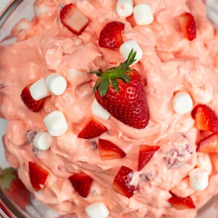 An overhead view of a glass bowl of strawberry fluff.
