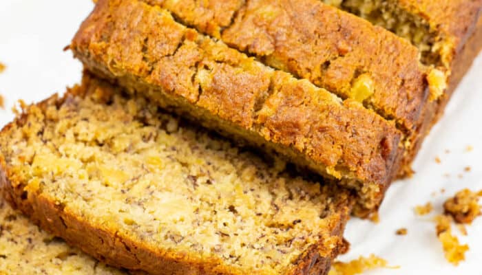 A close-up of a sliced loaf of pineapple banana bread.