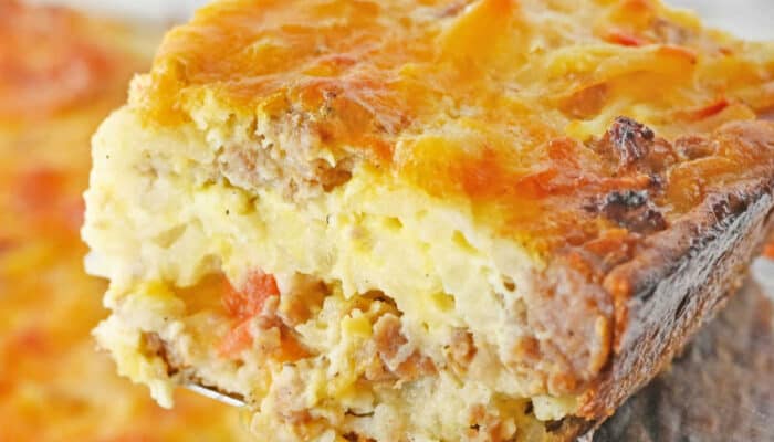 A close-up of a portion of bisquick breakfast casserole being scooped with a spatula.
