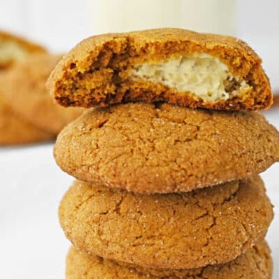 A close-up of several pumpkin cheesecake cookies stacked on top of each other.