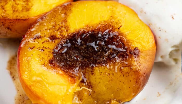 A close up of an air fryer peach with a bite taken out