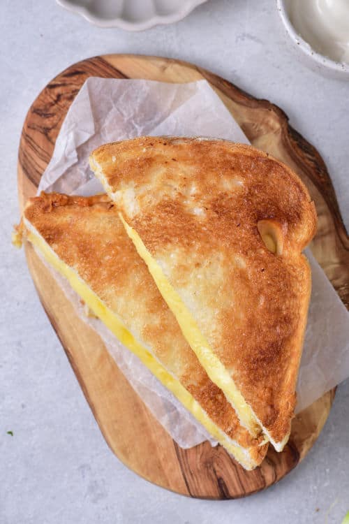 An overhead view of a diagonally sliced grilled cheese sandwich.
