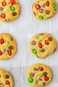 Christmas chocolate chip cookies on a parchment lined baking sheet
