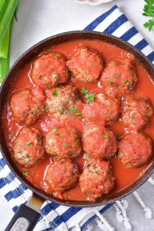 a pan full of meatballs and pasta sauce