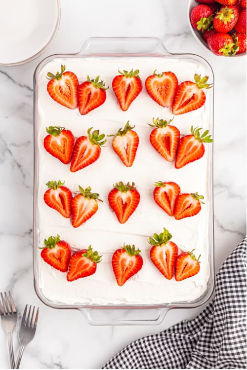 A strawberry delight dessert in a rectangle glass baking pan