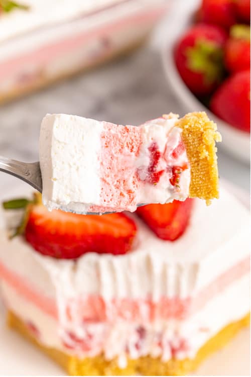 a fork with a bite of strawberry delight